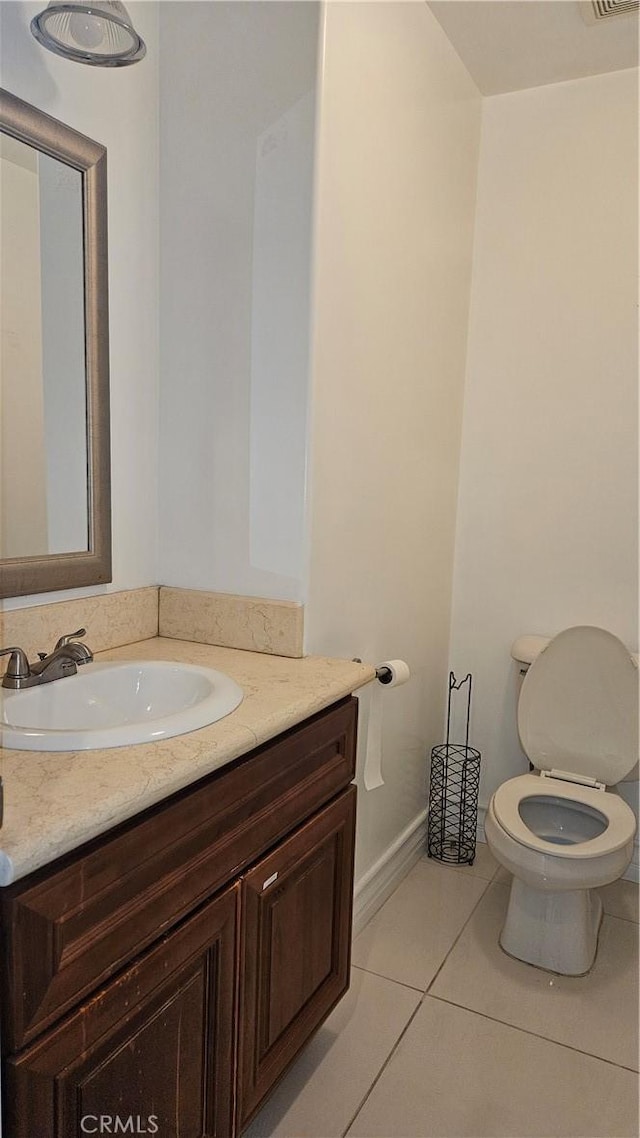 bathroom featuring toilet, vanity, and tile patterned flooring