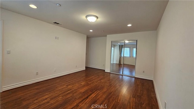 empty room featuring dark hardwood / wood-style flooring