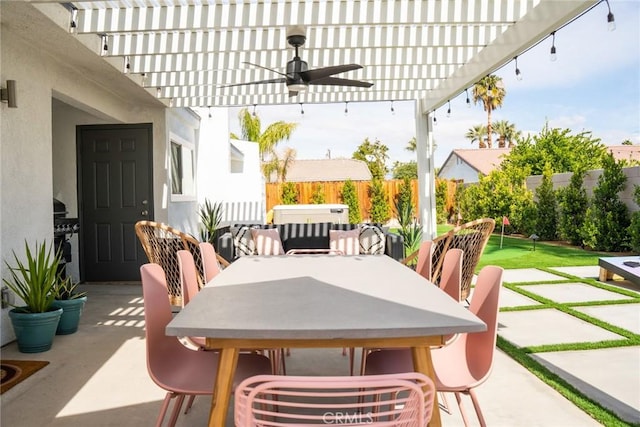 view of patio / terrace featuring ceiling fan, a hot tub, and a pergola