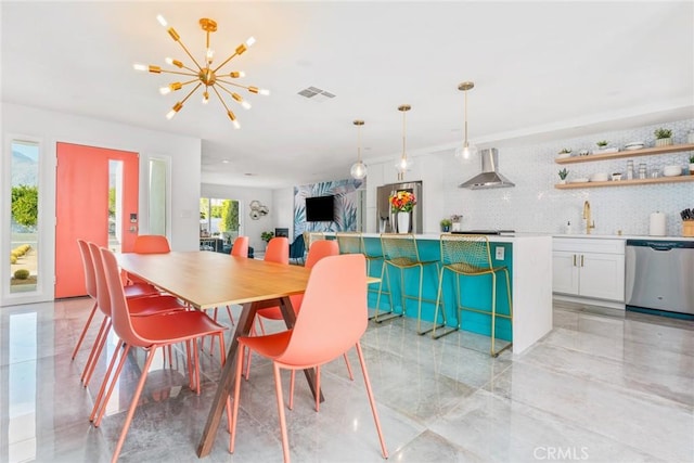 dining room with a chandelier and sink