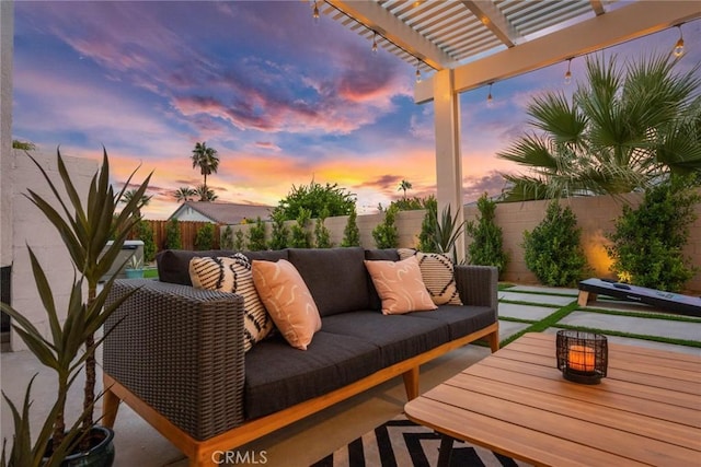 patio terrace at dusk featuring an outdoor hangout area and a pergola