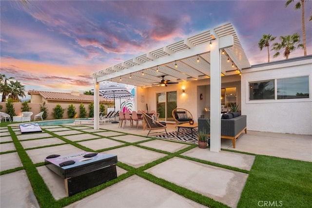 patio terrace at dusk with an outdoor hangout area and a pergola