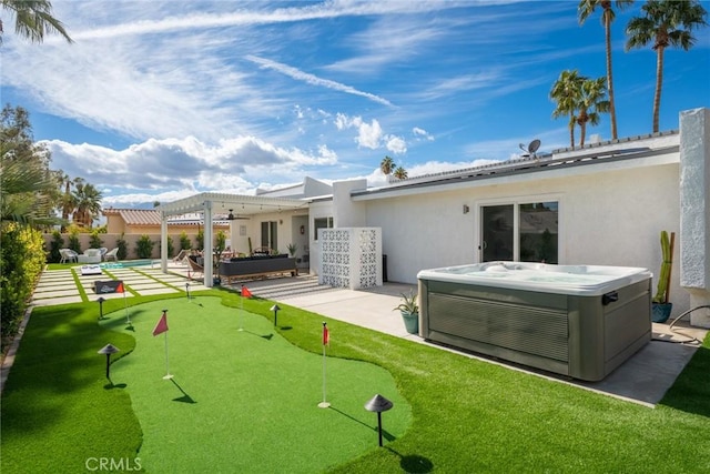 back of house featuring central AC unit, a pergola, a patio area, and a hot tub