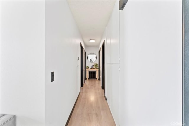 hallway with light hardwood / wood-style flooring