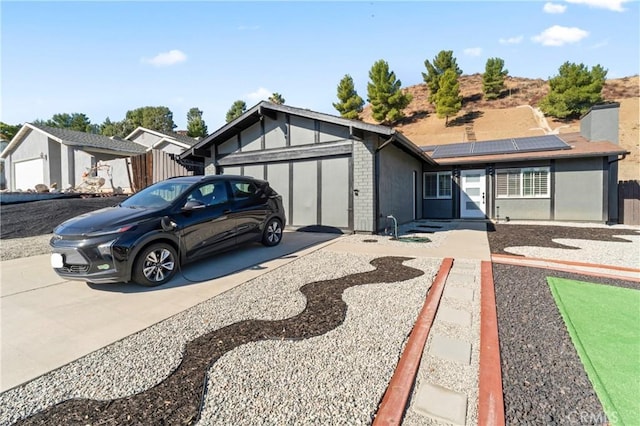 view of front of house featuring a garage and solar panels