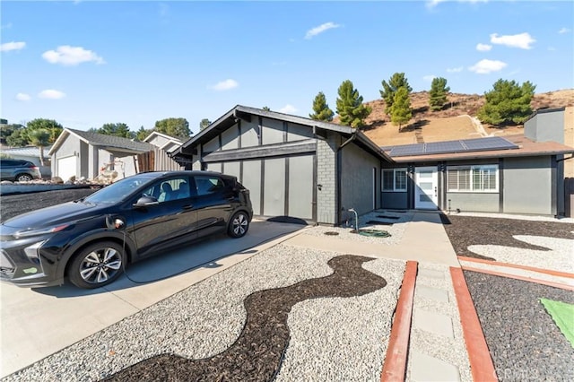 view of front of house with a garage and solar panels