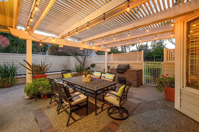 view of patio with grilling area and a pergola