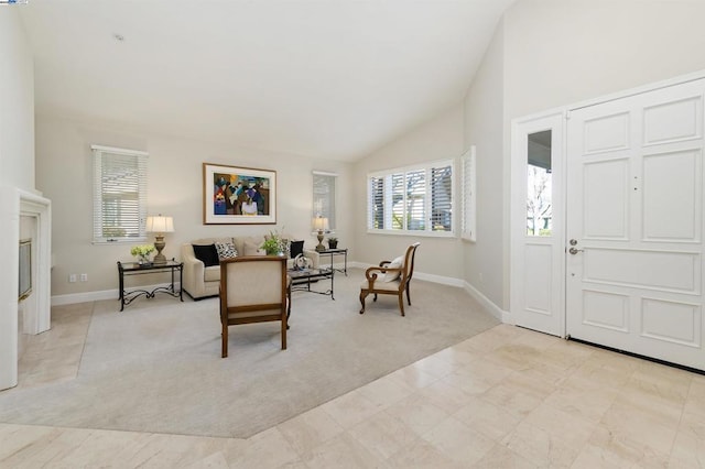 carpeted foyer with lofted ceiling