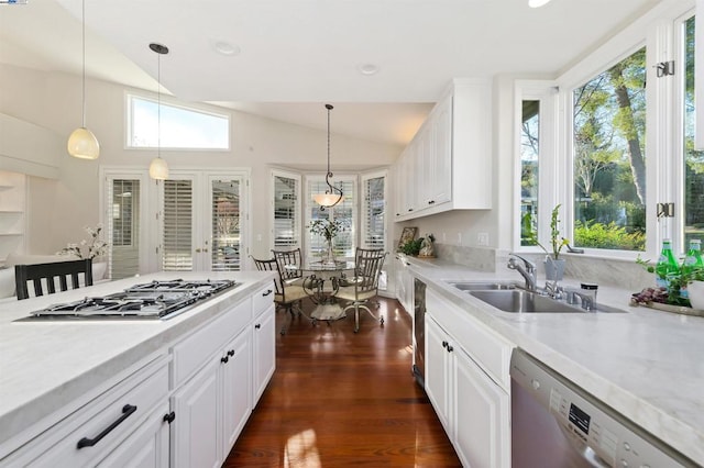 kitchen with pendant lighting, white cabinetry, stainless steel appliances, and sink