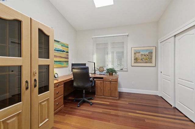 office with dark hardwood / wood-style floors and vaulted ceiling