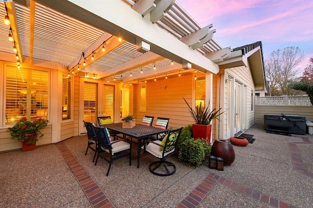 patio terrace at dusk featuring a pergola