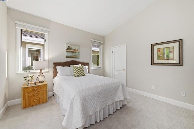 carpeted bedroom featuring vaulted ceiling