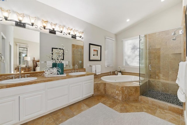 bathroom featuring lofted ceiling, plus walk in shower, and vanity