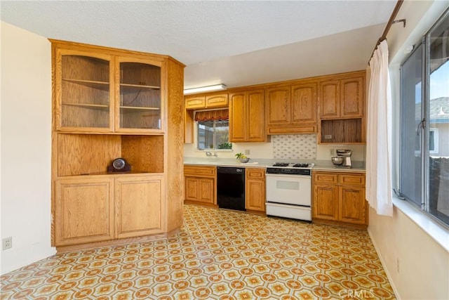 kitchen with sink, a wealth of natural light, black dishwasher, and white range