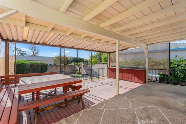 view of patio with a deck and a hot tub