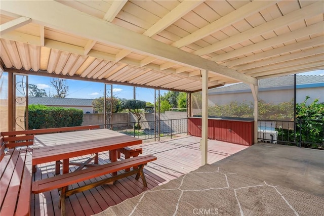 view of patio / terrace with a hot tub and a deck