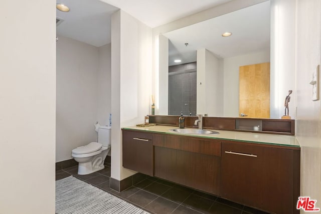 bathroom featuring toilet, tile patterned flooring, an enclosed shower, and vanity