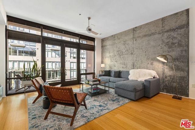 living room featuring ceiling fan and hardwood / wood-style floors