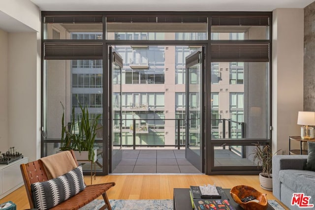 doorway featuring floor to ceiling windows and hardwood / wood-style floors