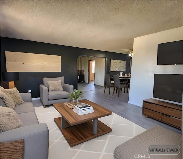 living room featuring a textured ceiling and light hardwood / wood-style flooring