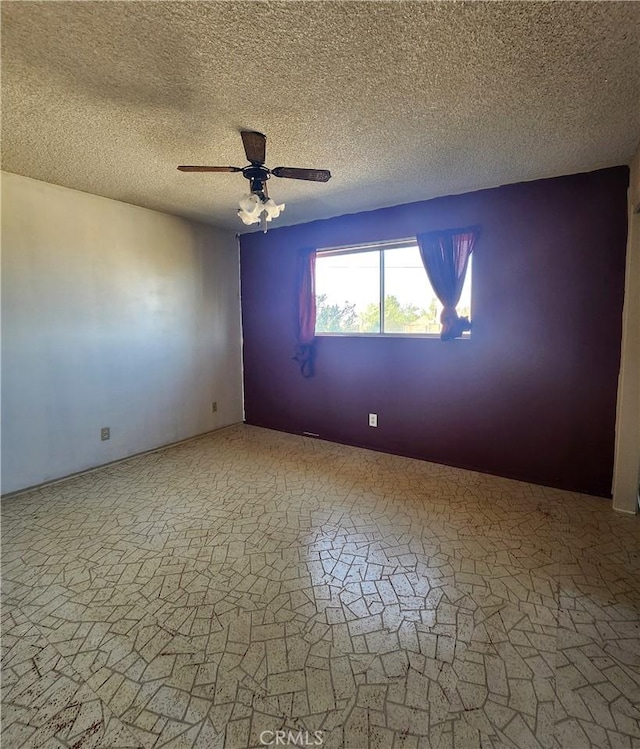 unfurnished room with a textured ceiling and ceiling fan