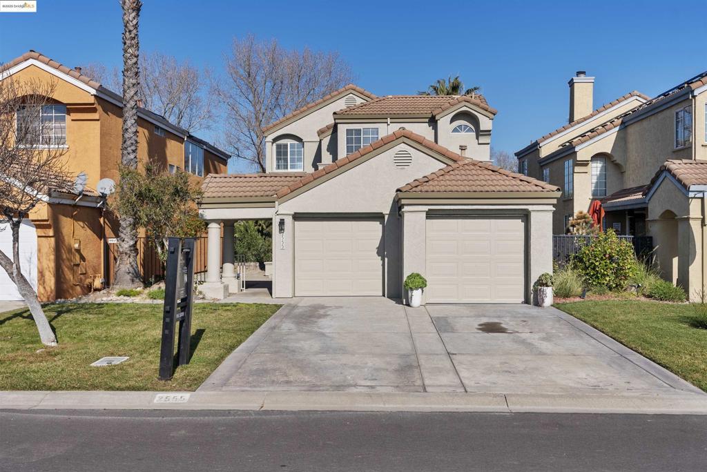 mediterranean / spanish-style house featuring a garage and a front lawn