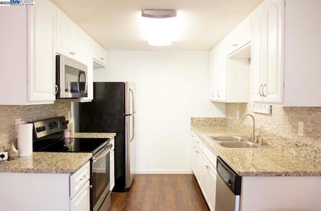 kitchen with white cabinetry, appliances with stainless steel finishes, tasteful backsplash, dark hardwood / wood-style flooring, and sink