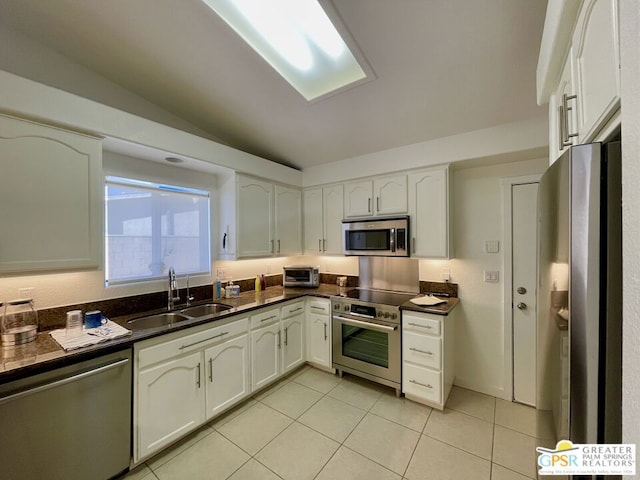 kitchen with sink, white cabinetry, and stainless steel appliances