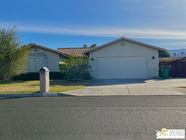 ranch-style house featuring a front yard and a garage