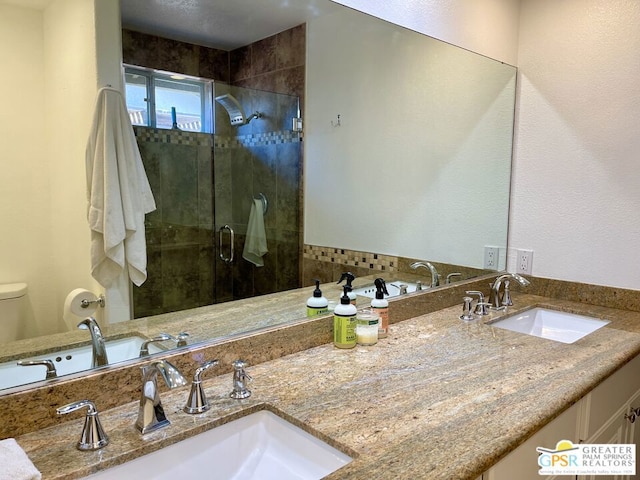 bathroom featuring vanity, toilet, and an enclosed shower