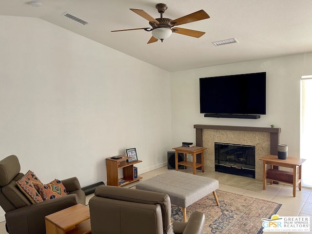 tiled living room with ceiling fan and lofted ceiling