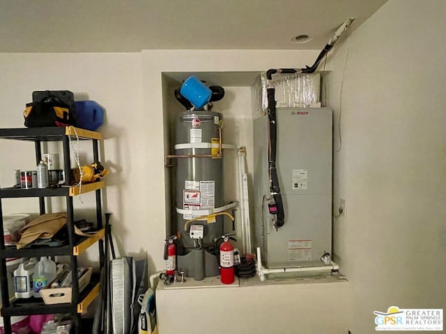 utilities featuring heating unit and strapped water heater