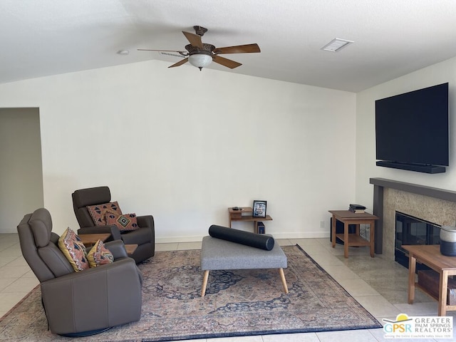 tiled living room with ceiling fan and vaulted ceiling