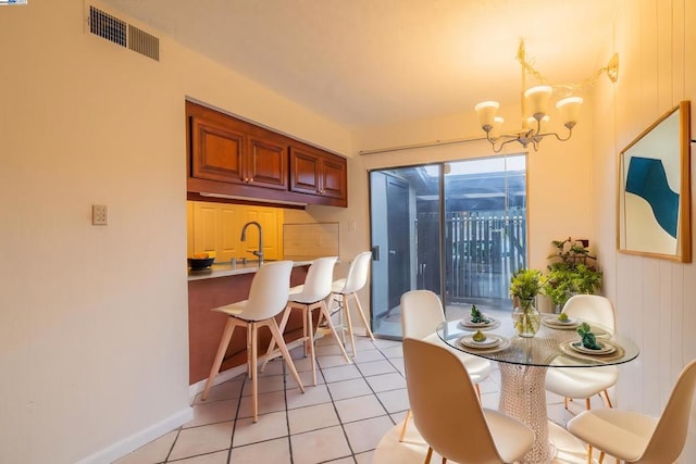 tiled dining area featuring a notable chandelier