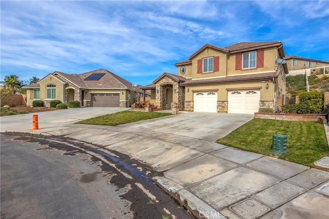 view of front of house with a garage, a front yard, and solar panels