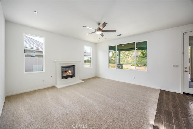 unfurnished living room featuring ceiling fan and hardwood / wood-style floors