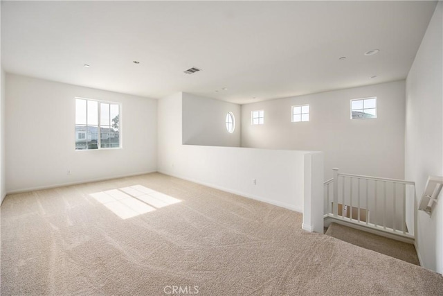 carpeted spare room with a wealth of natural light