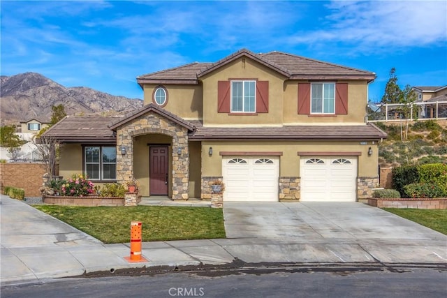 view of front of home featuring a garage and a mountain view