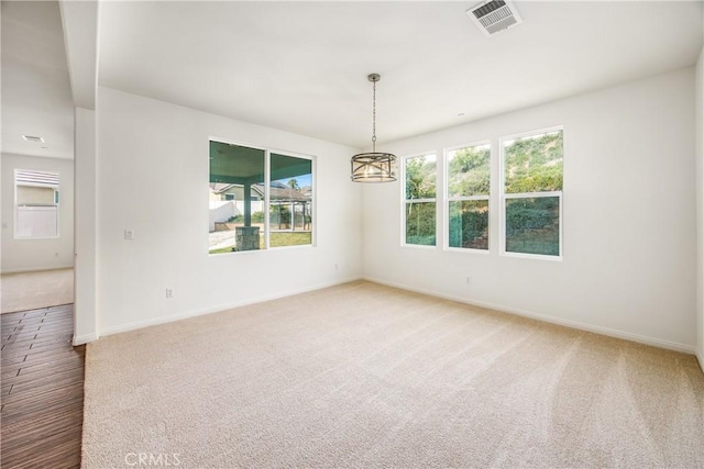 carpeted spare room with a healthy amount of sunlight