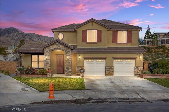 view of front facade with a garage and a mountain view