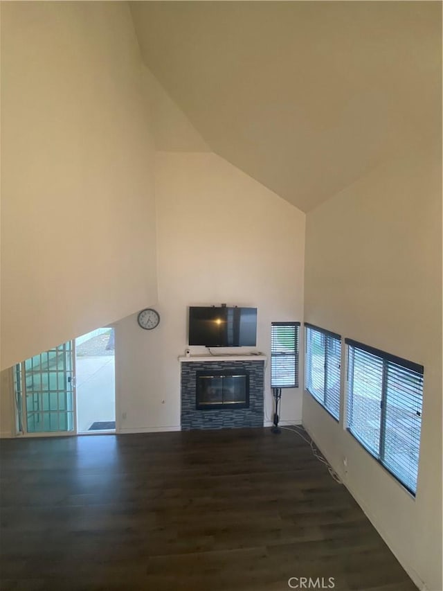 unfurnished living room with vaulted ceiling and dark hardwood / wood-style flooring