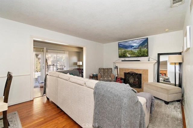 living room with wood-type flooring and a fireplace