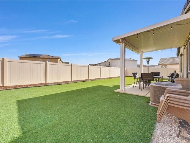 view of yard with central AC unit and a patio