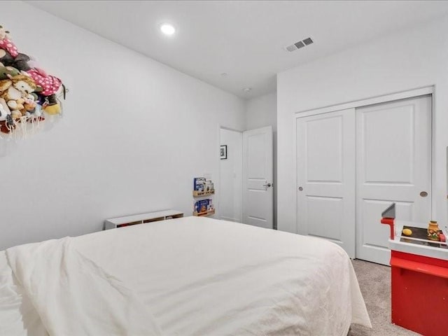 carpeted bedroom featuring a closet