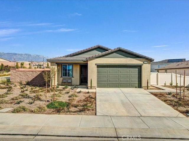 view of front facade with a garage and a mountain view