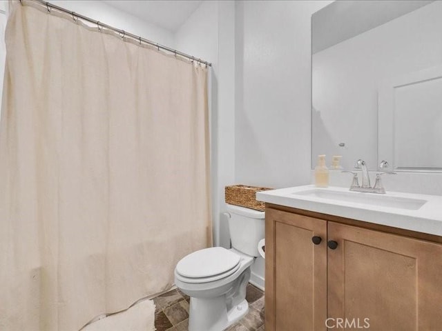 bathroom with toilet and vanity