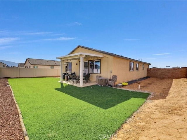 back of house with a patio area and a yard