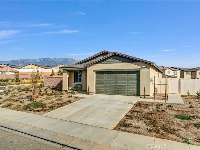 view of front facade with a mountain view and a garage