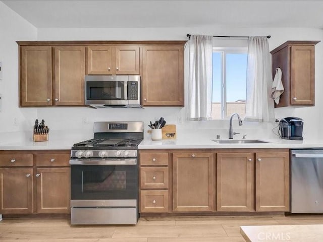 kitchen featuring sink, light hardwood / wood-style flooring, and stainless steel appliances