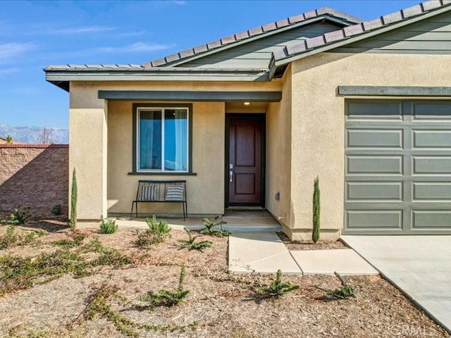 doorway to property with a garage